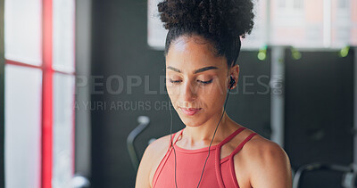 Buy stock photo Girl, gym and earphones for music, thinking and listening for inspiration to workout for wellness. African woman, audio streaming subscription and hearing for exercise, training or fitness with sound