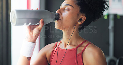 Buy stock photo Water, tired and woman with a break after fitness, training and exercise for health and music. Drink, bottle and face of a young girl at a club for wellness, workout and cardio and listening to audio
