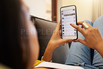 Buy stock photo Closeup of woman on her smartphone lying on a sofa, relaxing in a bright living room. A young latino female relaxing and texting on her cellphone using modern technology at home