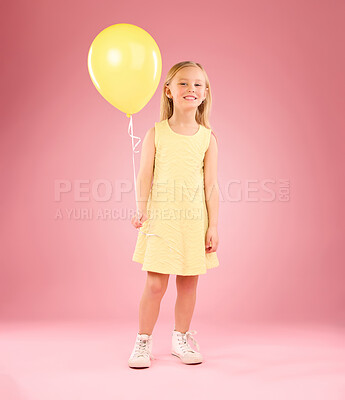 Buy stock photo Girl, child and portrait with a balloon in studio on a pink background with smile. Female kid model with happiness, creativity and yellow birthday party decoration in hand isolated on color and space