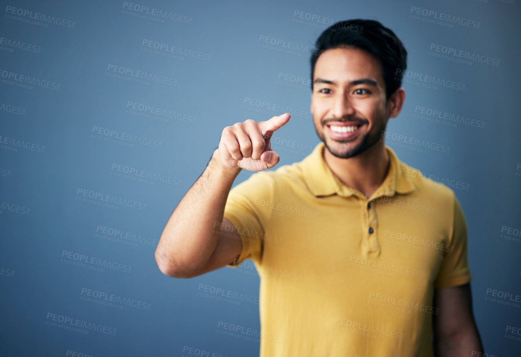 Buy stock photo Happy, finger and man in studio with hand for mockup space or ai on a blue background. Smile of an asian male model person pointing for product placement and creative brand isolated for gradient logo