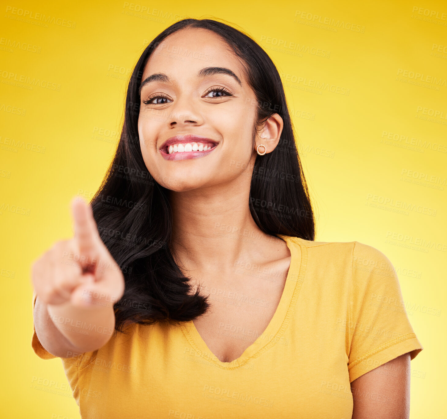 Buy stock photo Pointing, happy and portrait of a woman in a studio with a smile and positive face expression. Happiness, finger and female model from Puerto Rico with a showing hand gesture by a yellow background.