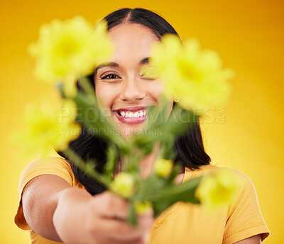 Buy stock photo Happy, portrait and a woman showing flowers isolated on a yellow background in a studio. Floral, spring and a girl giving a bouquet as a present, sharing plants and fresh flower with a smile