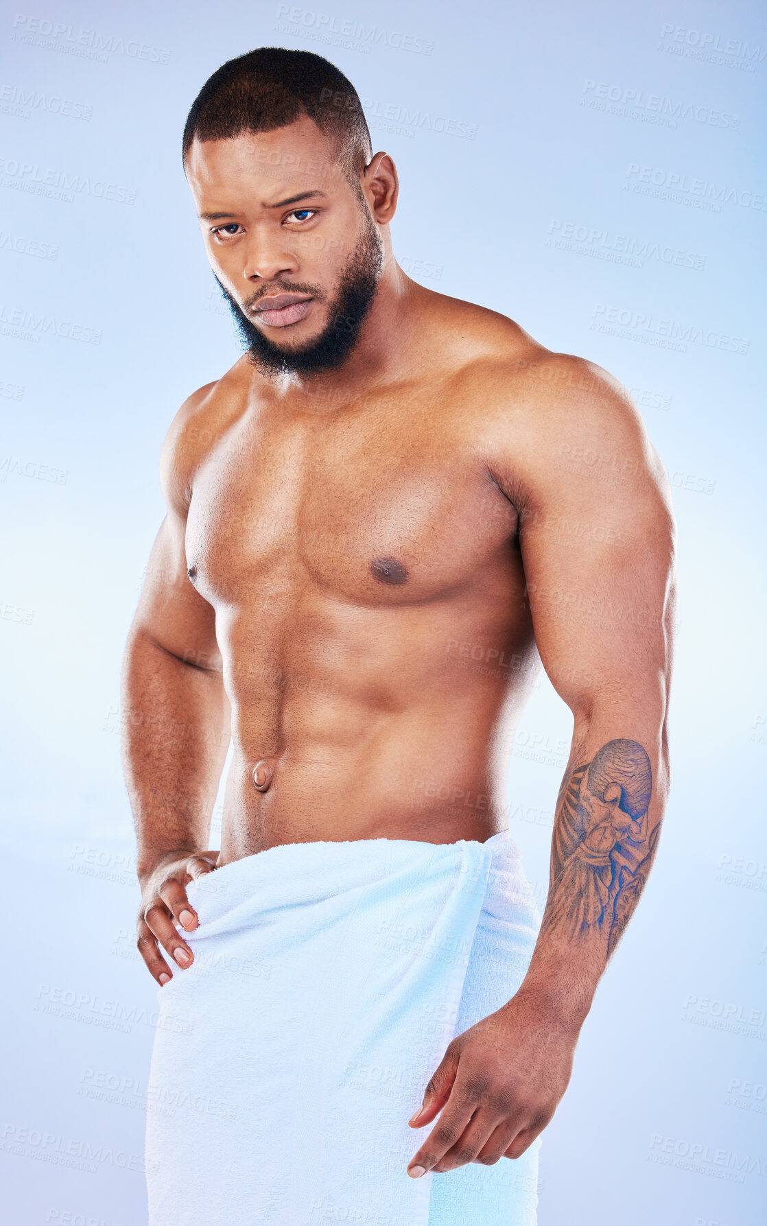 Buy stock photo Portrait, skincare and body with a man on white background and wearing a towel in studio after cleaning. Hygiene, grooming and serious muscular african male model posing shirtless in his bathroom