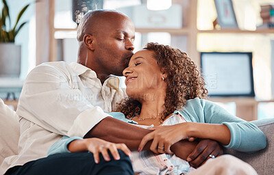 Buy stock photo Love, kiss and couple relax on sofa for bonding, quality time and happiness together at home. Marriage, relationship and interracial man and woman on couch for calm, romance and embrace on weekend