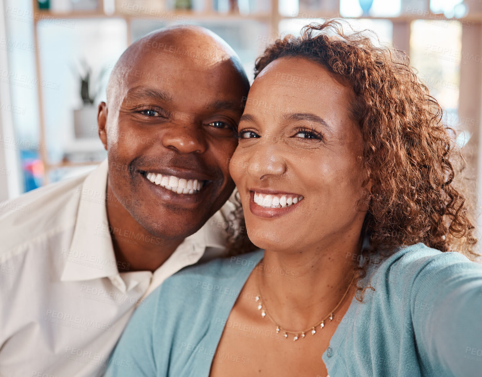 Buy stock photo Selfie, happy and portrait of couple in home for bonding, quality time and relax together in living room. Love, relationship and interracial man and woman smile for picture for social media or memory