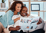 Couple, happy and reading newspaper in home, living room and check article information. Man, woman and smile in house with local magazine, print media and knowledge of international news in paper 