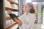 Pharmacy, inventory and woman with tablet, stock and check healthcare medicine in store. Female pharmacist, employee and medical professional with device, pills and inventory to update information