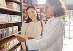 Dispensary, medication or prescription with a pharmacist and asian woman customer talking about a product. Healthcare, consultant and a medicine professional talking to a happy female in a pharmacy