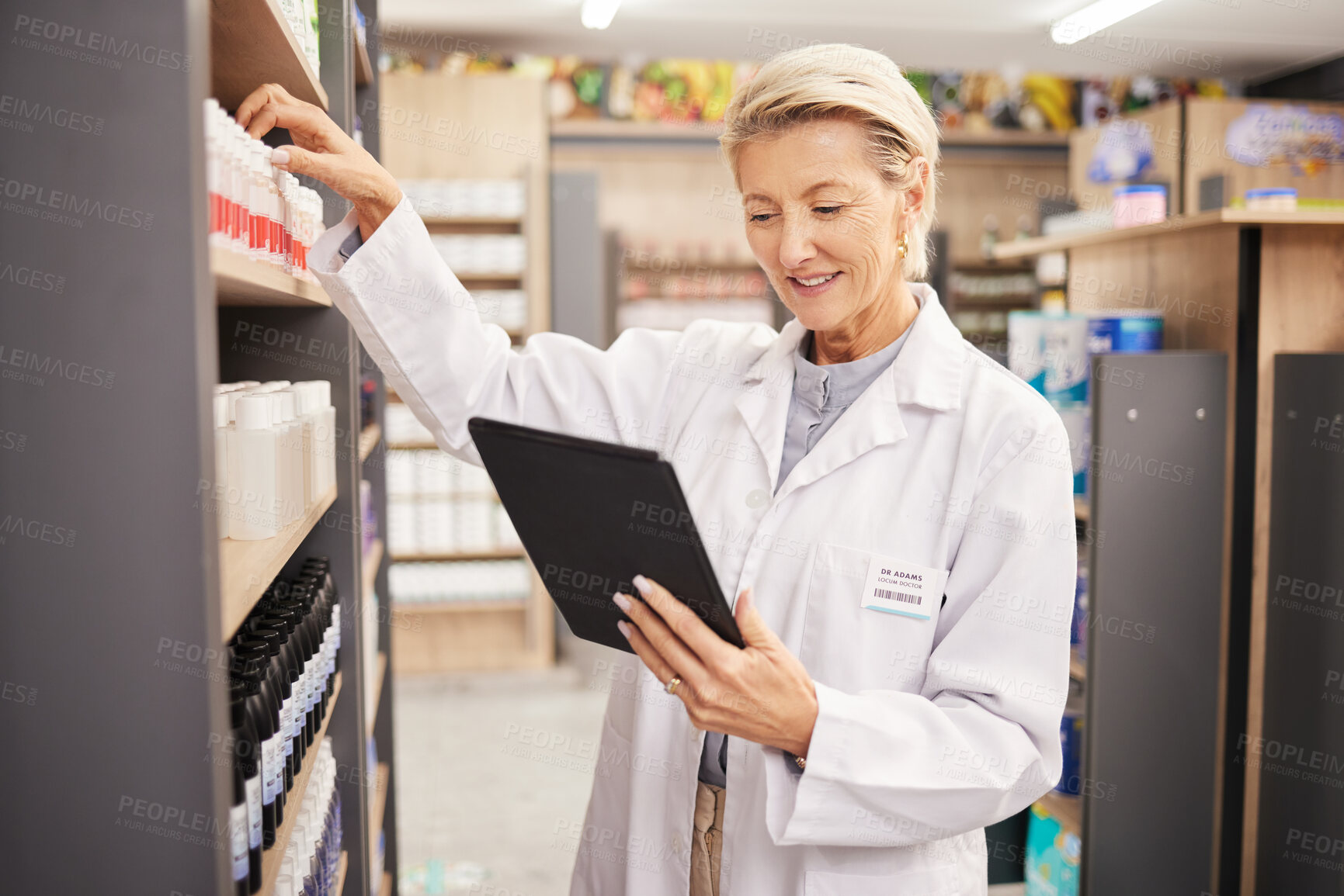 Buy stock photo Pharmacist, stock or woman with tablet, check inventory or medication information with technology. Mature female, lady or medical professional with device, pharmacy or supplements with online reading