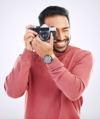 Buy stock photo Photography, happy and man with a camera in a studio for creativity or art photoshoot job. Happiness, smile and Indian male photographer taking pictures for paparazzi or the media by white background