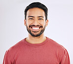 Happy, handsome and a headshot portrait of an Asian man isolated on a white background in studio. Smile, pride and a guy with confidence, happiness and attractive while smiling on a backdrop