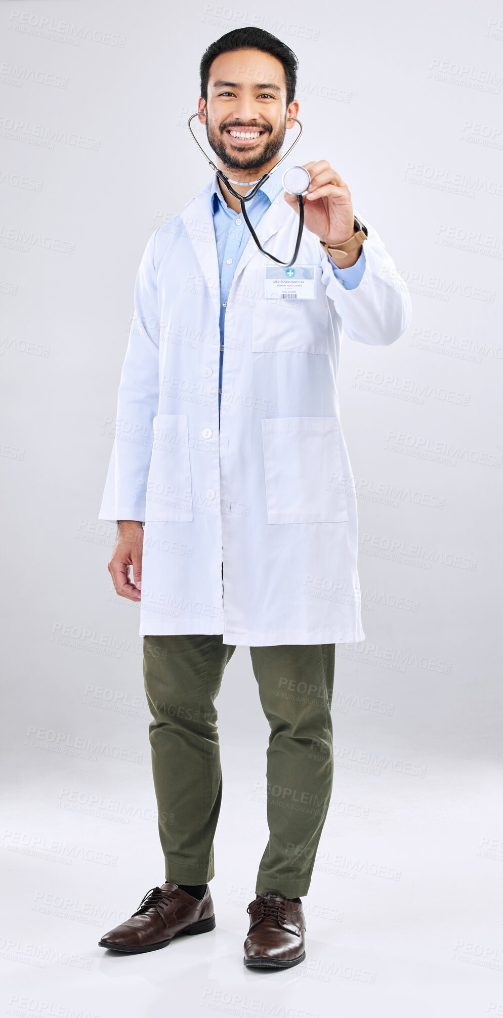 Buy stock photo Doctor, man and listen with stethoscope, smile in portrait and cardiovascular health isolated on studio background. Medical professional, happy male physician with healthcare, cardiology and surgeon