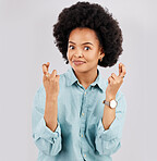 Luck, woman portrait and hands and fingers crossed with hope and in a studio. Isolated, gray background and young female model with hopeful face and emoji hand sign hopeful and waiting for win