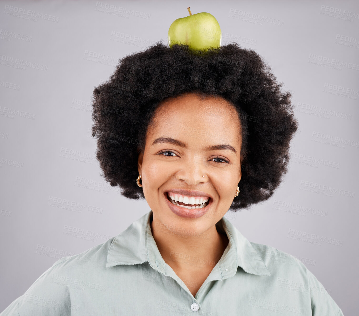 Buy stock photo Apple on head, balance and portrait of black woman in studio for nutrition, wellness and healthy snack. Food, diet and girl smile with fruit for detox, vitamins and weight loss on white background