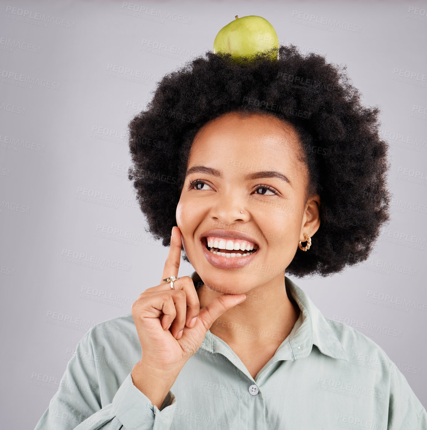 Buy stock photo Thinking, apple on head and black woman with happiness, wellness and health on a grey studio background. African American female, fruit and lady with ideas, planning diet and wellness with body care