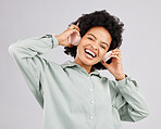 Portrait, music headphones and black woman singing in studio isolated on white background. Singer, radio and happiness of person listening, streaming and enjoying audio track, sound album or podcast.