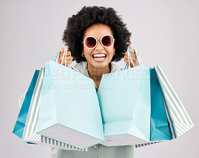 Buy stock photo Portrait, shopping bags and black woman laughing with sunglasses in studio isolated on a white background. Sales deals, fashion and happiness of rich, funny and wealthy person with retail products.