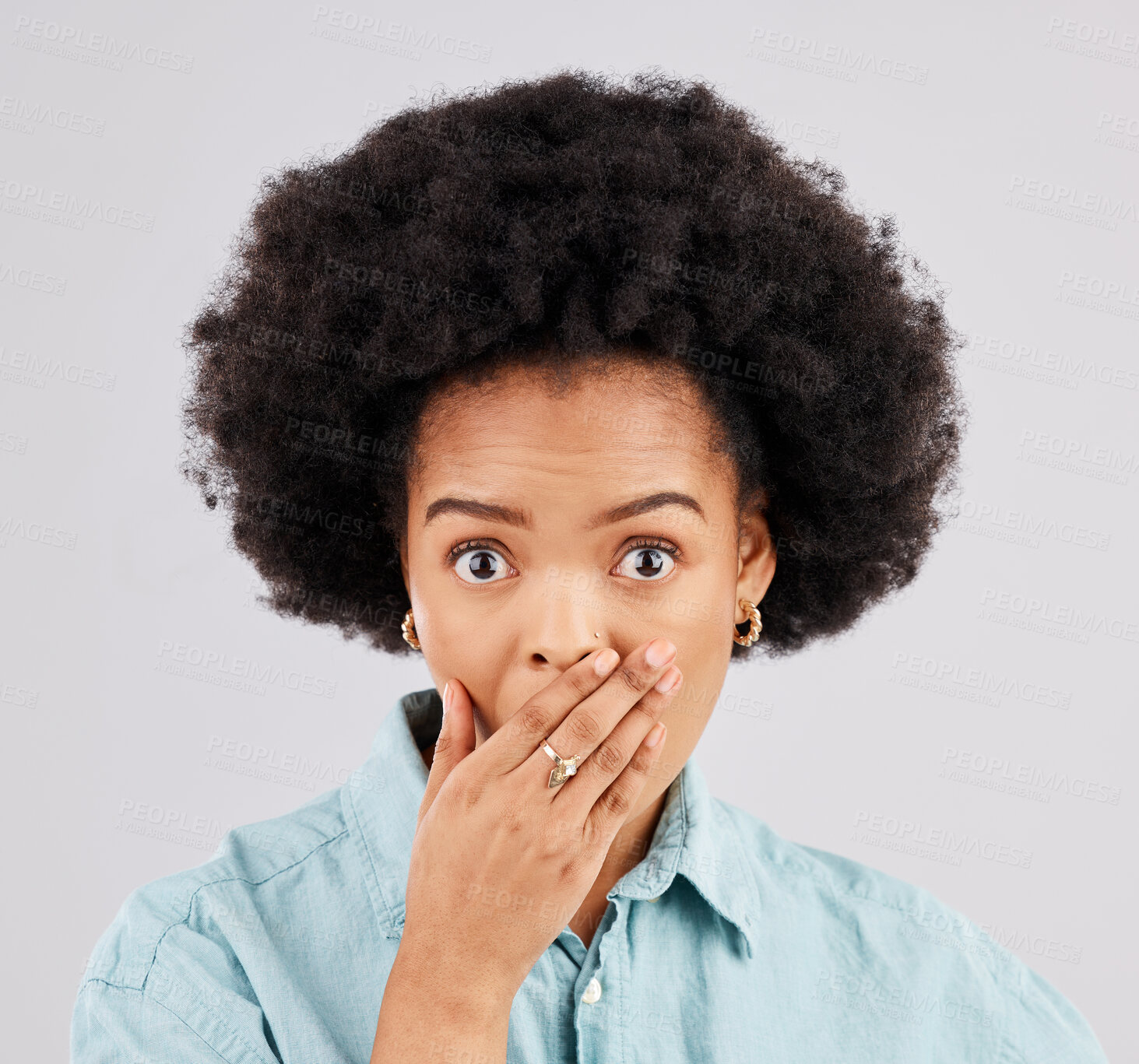 Buy stock photo Portrait, hand and mouth with a surprised woman in studio on a gray background feeling shocked by gossip. Face, wow or afro and a young female hearing news with an omg or wtf expression of disbelief