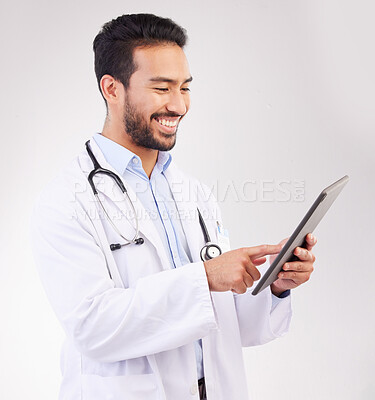 Happy asian man, doctor and tablet in medical research, Telehealth or communication against a white studio background. Male healthcare professional smiling on touchscreen for good health results
