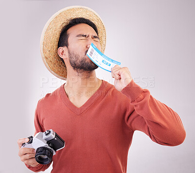 Buy stock photo Excited man, ticket and visa with camera, travel and paperwork for holiday adventure and on white background. Smile, travel and happy person kissing boarding pass for vacation, journey and happiness.