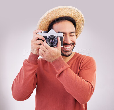 Buy stock photo Travel, camera and happy man on holiday, adventure and fun on white background. Smile, travel and person taking picture, photographer or tourist in studio for summer vacation, journey and happiness.