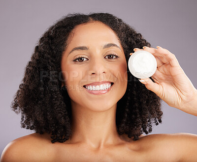 Buy stock photo Happy woman, face and portrait smile for moisturizer, beauty or skincare against a gray studio background. Female smiling with teeth holding cosmetic product for healthy skin or soft facial treatment