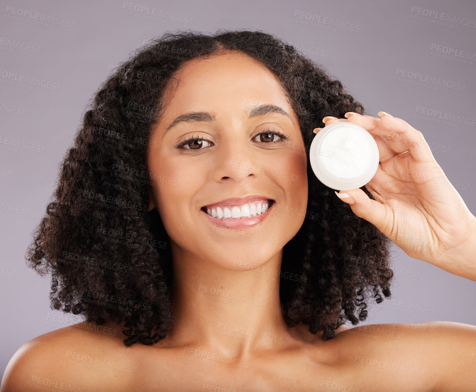 Buy stock photo Happy woman, face and portrait smile for moisturizer, beauty or skincare against a gray studio background. Female smiling with teeth holding cosmetic product for healthy skin or soft facial treatment