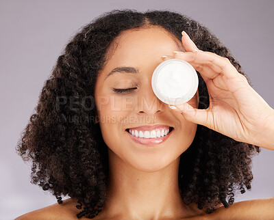 Buy stock photo Happy woman, face and smile for skincare moisturizer or beauty against a gray studio background. Female smiling with teeth holding cosmetic product for healthy skin, self care or facial treatment