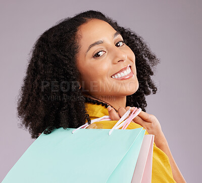 Buy stock photo Woman, face and portrait smile with shopping bags for discount, sale or fashion against gray studio background. Happy female shopper smiling and holding gifts or shop accessories posing in happiness