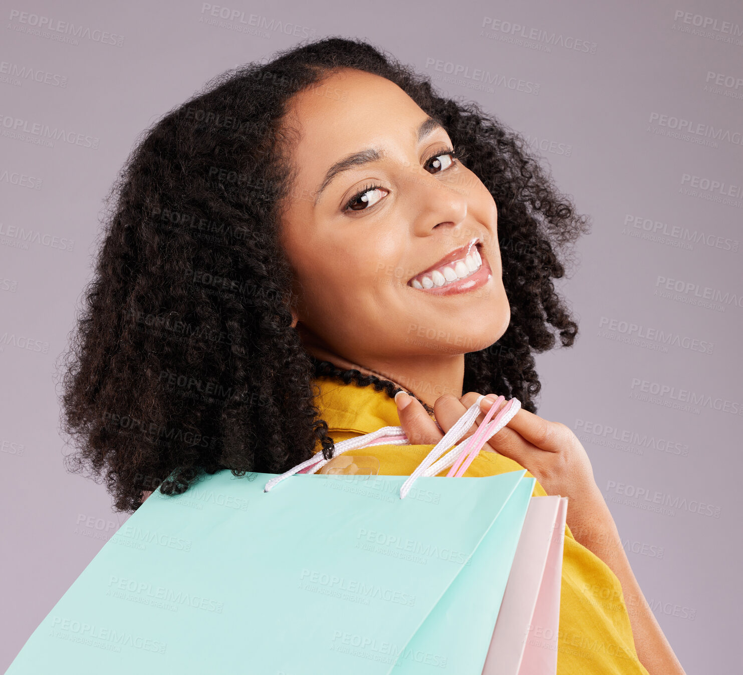 Buy stock photo Woman, face and portrait smile with shopping bags for discount, sale or fashion against gray studio background. Happy female shopper smiling and holding gifts or shop accessories posing in happiness