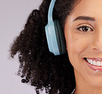 Headphones, happy woman and portrait of half face, studio background and backdrop. Closeup female model, smile and listening to music, sound and streaming media for audio connection, podcast or radio