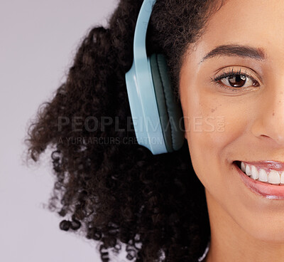 Buy stock photo Headphones, happy woman and portrait of half face, studio background and backdrop. Closeup female model, smile and listening to music, sound and streaming media for audio connection, podcast or radio