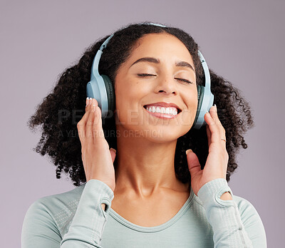 Buy stock photo Happy woman, headphones and smile listening to music in joy against a gray studio background. Fun and calm female smiling and relaxing in happiness with headset for audio track, sound or podcast