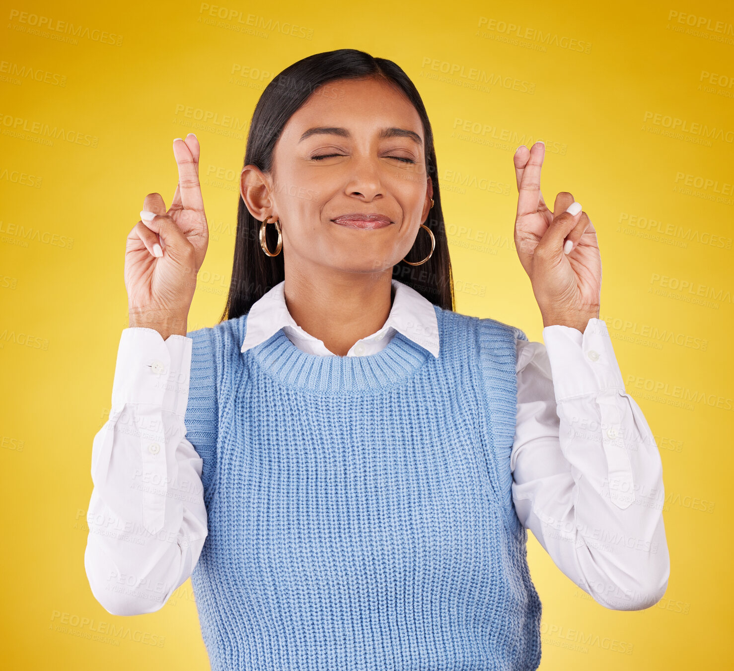 Buy stock photo Hope, fingers crossed and woman model in studio wishing for success, winning or achievement. Happiness, smile and excited Indian female with a luck hand gesture or emoji isolated by yellow background