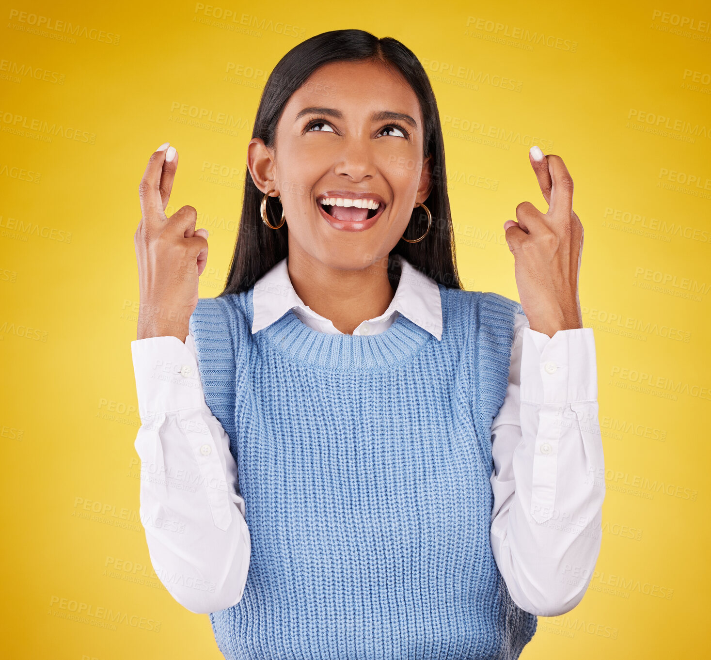 Buy stock photo Hope, fingers crossed and young woman in a studio wishing for success, winning or achievement. Happiness, smile and excited Indian female model with a faith hand gesture isolated by yellow background