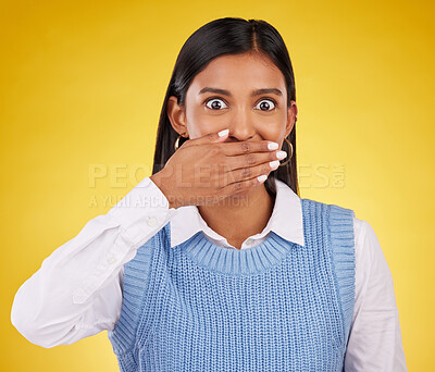Buy stock photo Portrait, wow and gossip with a woman on a yellow background in studio looking surprised by an announcement. Face, shock and news with an attractive young female standing hand over mouth in awe