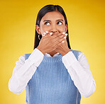 Shock, omg and young female in a studio with her hand on her mouth for a wtf expression. Shocked, ecstatic and Indian woman model with wow or surprise face for good news isolated by yellow background