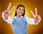 Hands, peace sign and portrait of Indian woman in studio for happiness, confident and smile on yellow background. Emoji mockup, fashion and girl with hand gesture with beauty, cosmetics and style