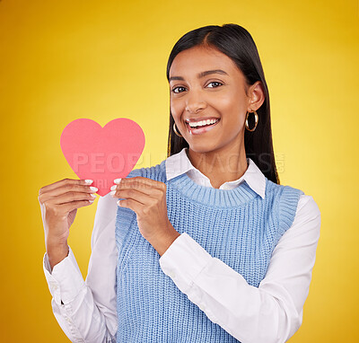 Buy stock photo Happy, paper and heart with portrait of woman in studio for love, support and romance. Valentines day, kindness and date with female and symbol on yellow background for health, happiness and hope