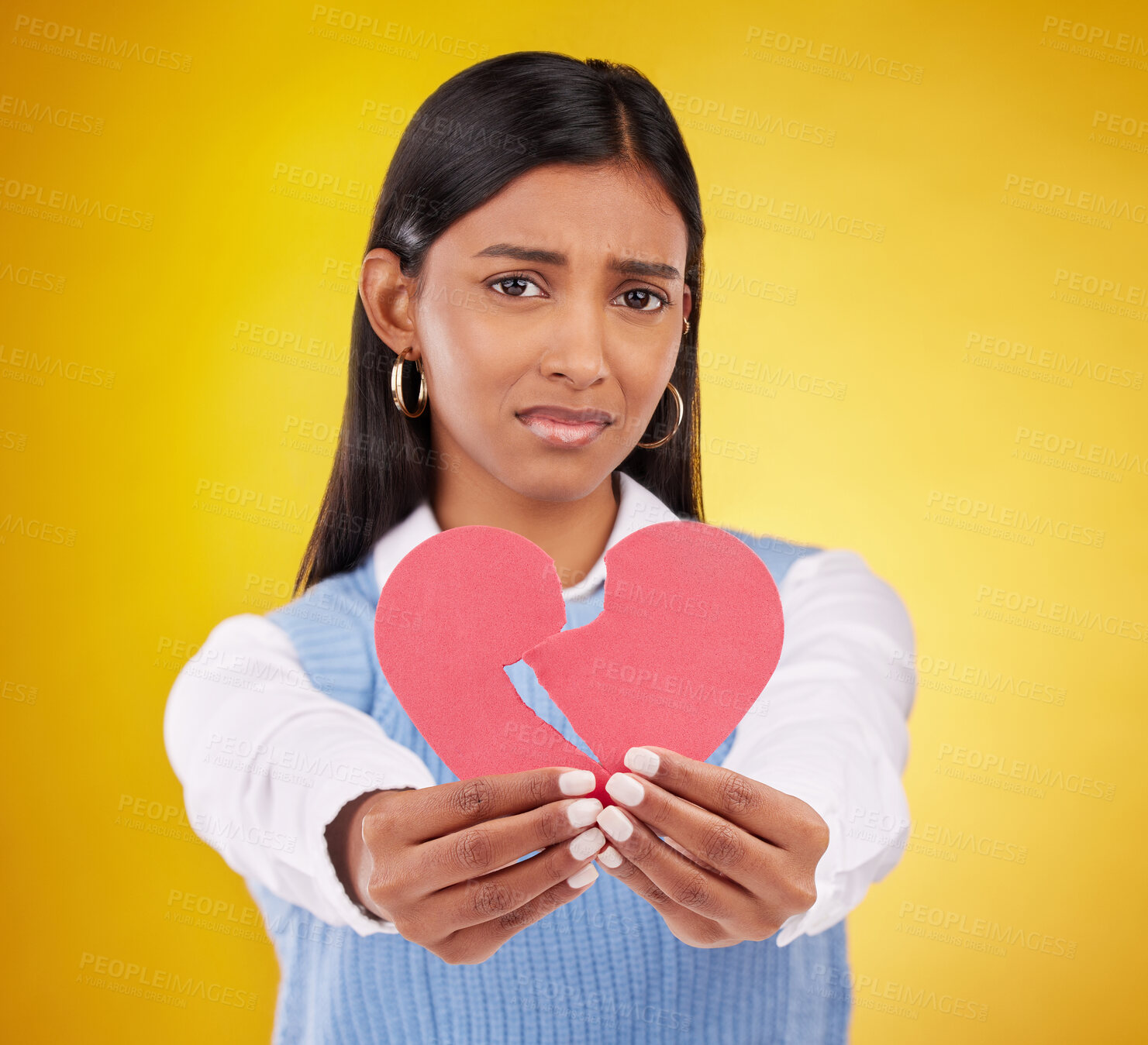 Buy stock photo Heartbreak, sad and woman in a studio with paper icon and emoji from break up. Depressed, isolated and yellow background of a person portrait feeling unhappy, grief and disappointed from love loss
