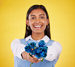 Portrait, love and roses with a woman on a yellow background in studio for valentines day. Face, blue flowers or smile with a happy young female holding a plant for romance or anniversary celebration
