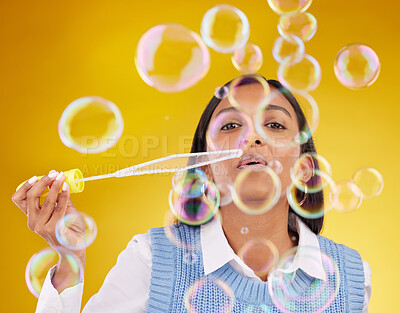 Buy stock photo Portrait, fun and woman blowing bubbles, positive attitude and cheerful against a studio background. Face, female and lady with soap bubble, excitement and joyful with wellness, break and playful