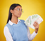 Young woman and money fan isolated on studio background of wealth, cash winning or financial freedom ideas. Rich and confident indian person or winner thinking of investing bonus, cashback or lottery
