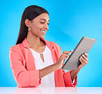 Happy woman, tablet and smile for research, browsing or social media and communication against a blue studio background. Female employee working on touchscreen for business data or search on mockup