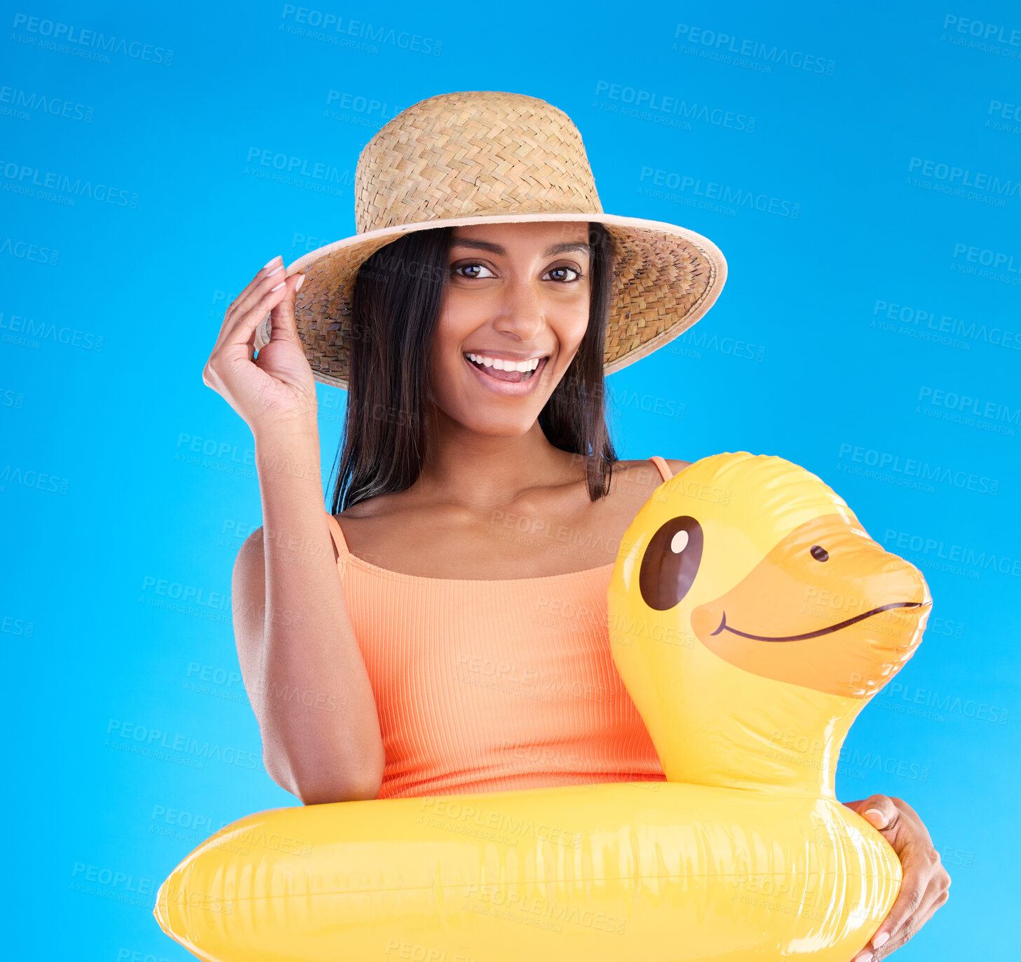 Buy stock photo Portrait, hat and rubber duck with a woman on a blue background in studio ready for summer swimming. Happy, travel and vacation with an attractive young female looking excited to relax or swim
