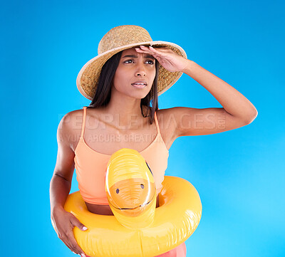 Buy stock photo Studio, shocked woman on beach and vacation on blue background, looking or search with hat and hand on face. Travel, pool holiday and worried girl with inflatable rubber duck, ocean wear on holiday.