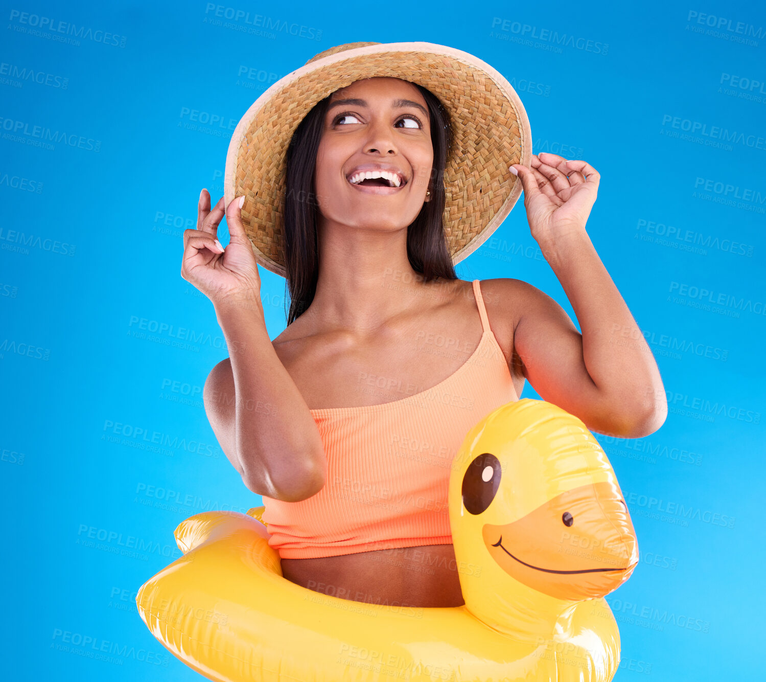 Buy stock photo Thinking, hat and rubber duck with a woman on a blue background in studio ready for summer swimming. Happy, travel and vacation with an attractive young female looking excited to relax or swim