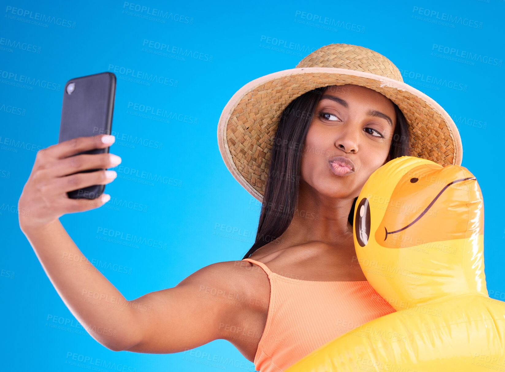 Buy stock photo Happy woman, selfie and swimming vacation for social media or profile picture with inflatable duck against a blue studio background. Excited female model in summer swimwear for photo, travel or trip