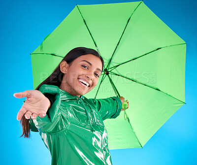 Buy stock photo Portrait, smile and woman with umbrella, excited and expression against blue studio background. Face, female and person with cover from rain, happiness and excitement with joy, adventure or insurance